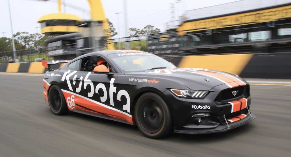 kubota race car speeding down the track with blurry background