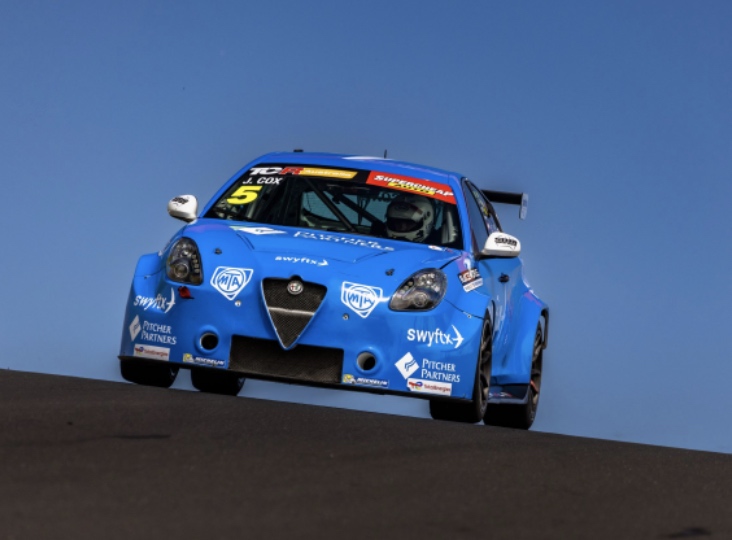 blue race car coming up over horizon against a blue sky
